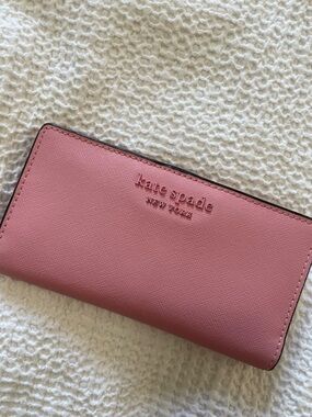 Kate Spade pink New York large slim bifold wallet